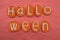 Halloween text with orange stone letters over orange colored sand
