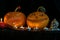 Halloween theme, carved pumpkin with a scary smile, burning candles, spiders and cobwebs, awful skulls, decoration and holiday