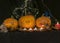 Halloween theme, carved pumpkin with a scary smile, burning candles, spiders and cobwebs, awful skulls, decoration and holiday