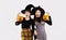 Halloween theme, young asian woman in black costume witch hat holding and carrying orange pumpkin bucket and lantern posing happy