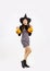 Halloween theme, young asian woman in black dress and boots wear witch hat holding and carrying orange pumpkin bucket and lantern