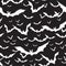 Halloween themed background with bats silhouettes on black background