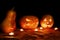 Halloween three pumpkins jack lamp in the darkness among the can