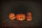 Halloween three pumpkins scary funny and creepy in the woods on