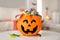 Halloween trick or treat bucket with different sweets on white table indoors