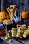 Halloween trick or treat party. Funny delicious food and pumpkin on wooden background - mini pizza, bread sticks, cheese, olives,