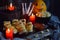 Halloween trick or treat party. Funny delicious food and pumpkin on wooden background - mini pizza, bread sticks, cheese, olives,