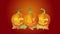 Halloween Twinkling Candle Lit Dancing Carved Pumpkins with Autumn Leaves on Red Background