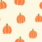 Halloween vector all over pattern with orange pumpkins on cream