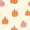 Halloween vector pattern with orange and pink pumpkins on cream