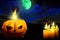 Halloween vivid haunting dark night texture - pumpkin candle on the left and many candles on the right, glowing candles concept -