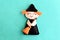 Halloween witch doll on a blue felt background. Halloween decor toy instructions step. Top view. Closeup