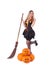 Halloween witch in dress with pumpkin, broom