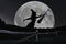 Halloween witch silhouette flying with broomstick. Full Moon.