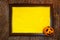 Halloween. Wooden frame with web, orange pumpkin and yellow paper blank space for text on tree bark. List for recording