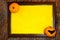 Halloween. Wooden frame with web, orange pumpkins, bat and yellow paper blank space for text on tree bark. List for recording