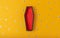 Halloween yellow background with an open red-black coffin in the center, around a scattering of plastic eyes of different sizes. A