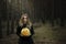 Halloween. yellow pumpkin. beautiful girl in a black dress in the forest.