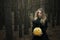 Halloween. yellow pumpkin. beautiful girl in a black dress in the forest.