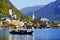 HALLSTATT, AUSTRIA, 19 OCTOBER, 2018: The hunters from Hallstatt town in a boat on the lake in a autumn foggy morning