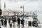 HALLSTATT, AUSTRIA - JANUARY 2019: tourists walking along the lake waterfront in the old town