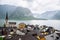 hallstatt church with bell tower lake with alpine mountains on background