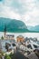 hallstatt church with bell tower lake with alpine mountains on background