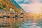 Hallstatt mountain resort village with famous church, traditional alps houses and wooden rural boat houses at Hallstatt lake