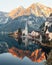 Hallstatt tranquil town situated beside a lake surrounded by majestic mountains during a sunset