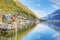 Hallstatt under blue sunny sky with reflections on smooth lake water