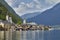 Hallstatt village landscape with old buildings reflected in blue lake.