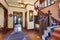 Hallway with brown trim and hardwood floor in old house.