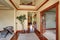 Hallway in creamy colors with polished hardwood floor and brown trim.