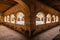 Hallway in a former 17th century Convent in central Mexico, with details of worn paint on the quarry walls and huge white arches.