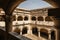 Hallway in a former 17th century Convent in central Mexico, with details of worn paint on the quarry walls and huge white arches.