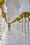 Hallway with golden decorated pillars at the entrance of the world famous Sheikh Sultan Zayed Mosque in Abu Dhabi UAE