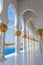 Hallway with golden decorated pillars at the entrance of the world famous Sheikh Sultan Zayed Mosque in Abu Dhabi UAE