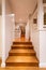 Hallway with hard wood flooring in luxury domestic home lit with down lights