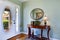 Hallway interior with antique furniture and hardwood floor.