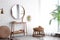 Hallway interior with big round mirror, table and decor