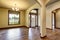 Hallway interior with columns, hardwood floor and white entry door