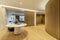 Hallway of luxury home with round table with vases, slatted walls