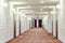 Hallway with many doors leading into hotel rooms.