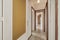 Hallway of a residential house with vintage terrazzo flooring and white painted