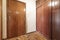 Hallway of a well-used residential home with dirty parquet