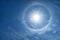 A halo around a radiant sun with lens flare