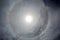 The halo is a circle around the sun as a rare natural phenomenon in the sky.