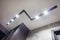 Halogen spots lamps on suspended ceiling and drywall construction in in empty room in apartment or house. Stretch ceiling white