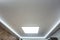 Halogen spots lamps on suspended ceiling and drywall construction in in empty room in apartment or house. Stretch ceiling white