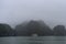 Halong Bay in mystical clouds. Mystical atmoshpere in the world famous halong bay.